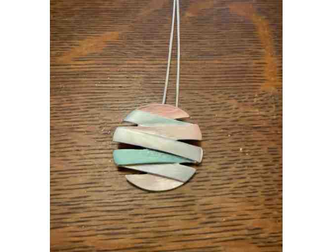 Small Round Jewelry Travel Organizer with necklace and earrings.