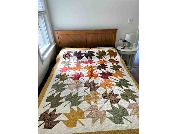 Beautiful fall themed quilt with large quilted maple leaves