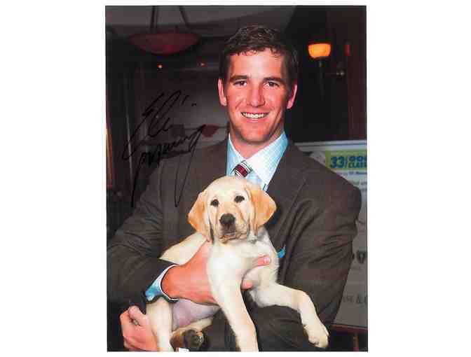 Autographed Photo of Eli Manning with Guiding Eyes Puppy