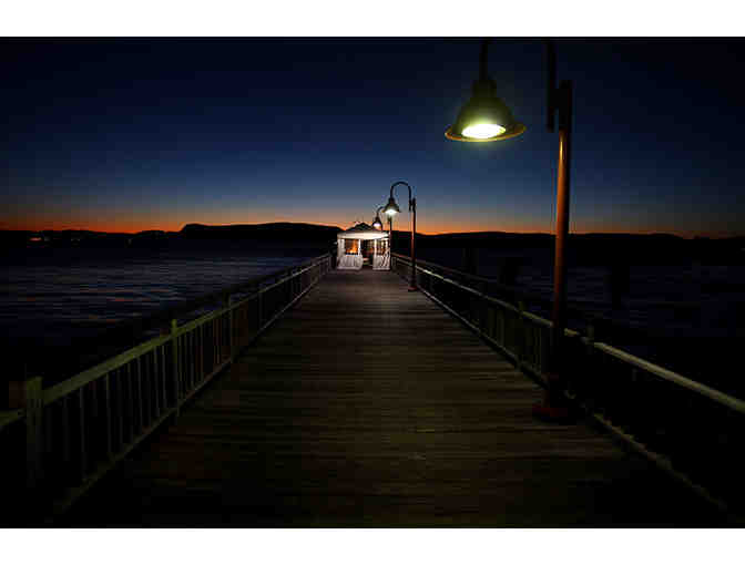 A framed photograph 'Ferry Dock at Sunset' by local photojournalist Craig Ruttle