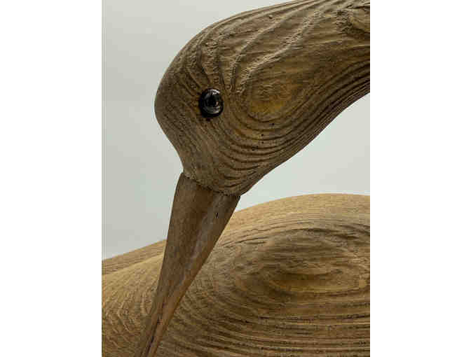 Carved shore bird on driftwood