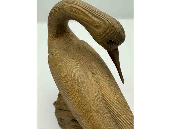 Carved shore bird on driftwood